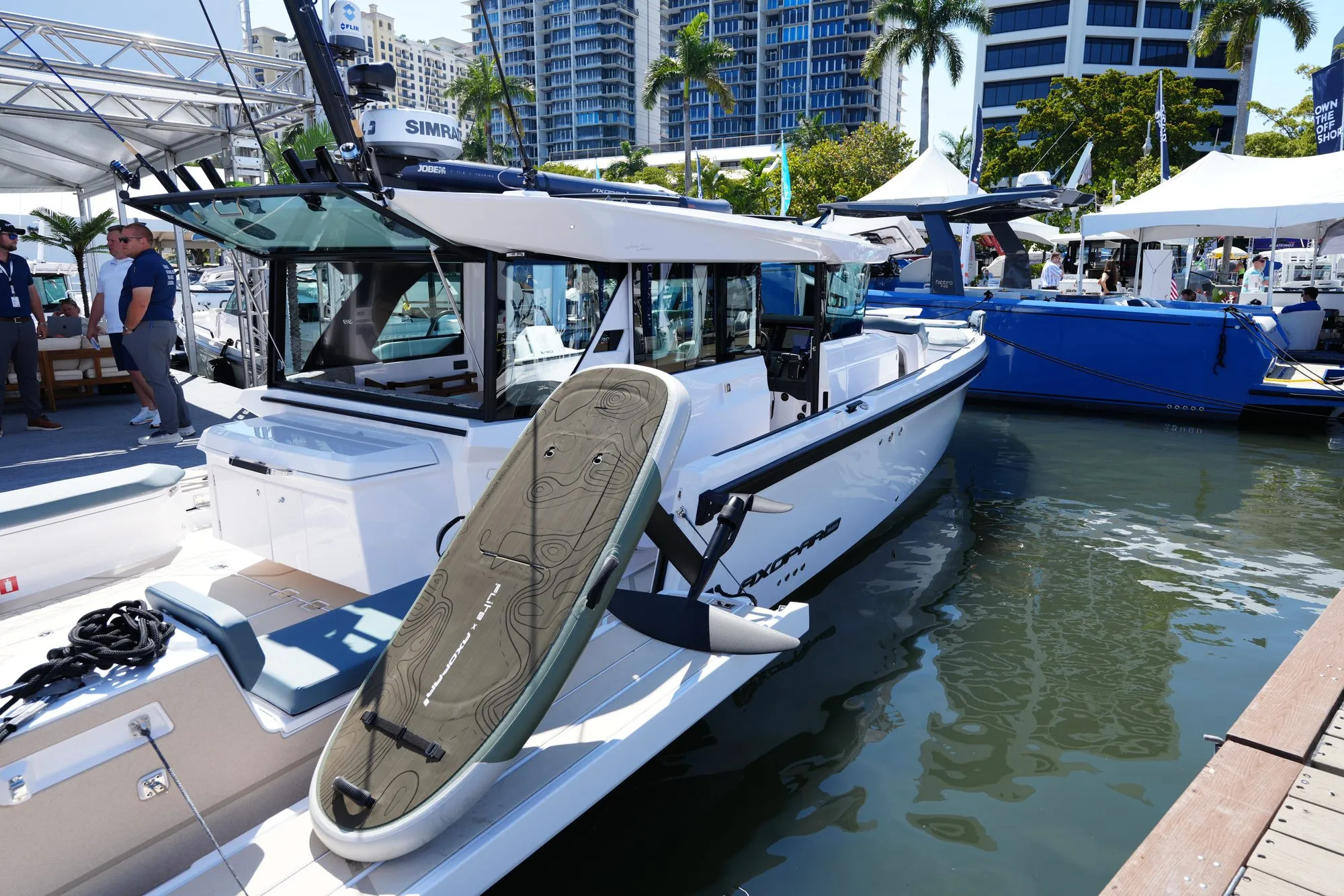Axopar with a Flite eFoil displayed on the dock at a boat show