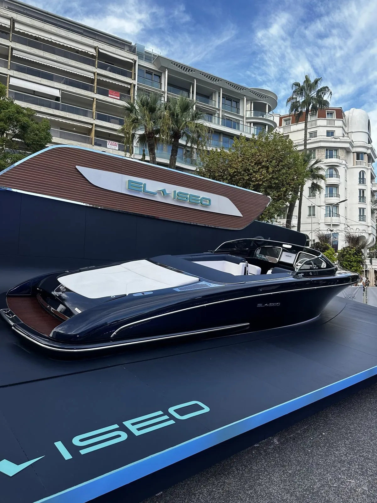 A Croisette palace hotel rising behind the yacht stands at the Cannes Yachting Festival