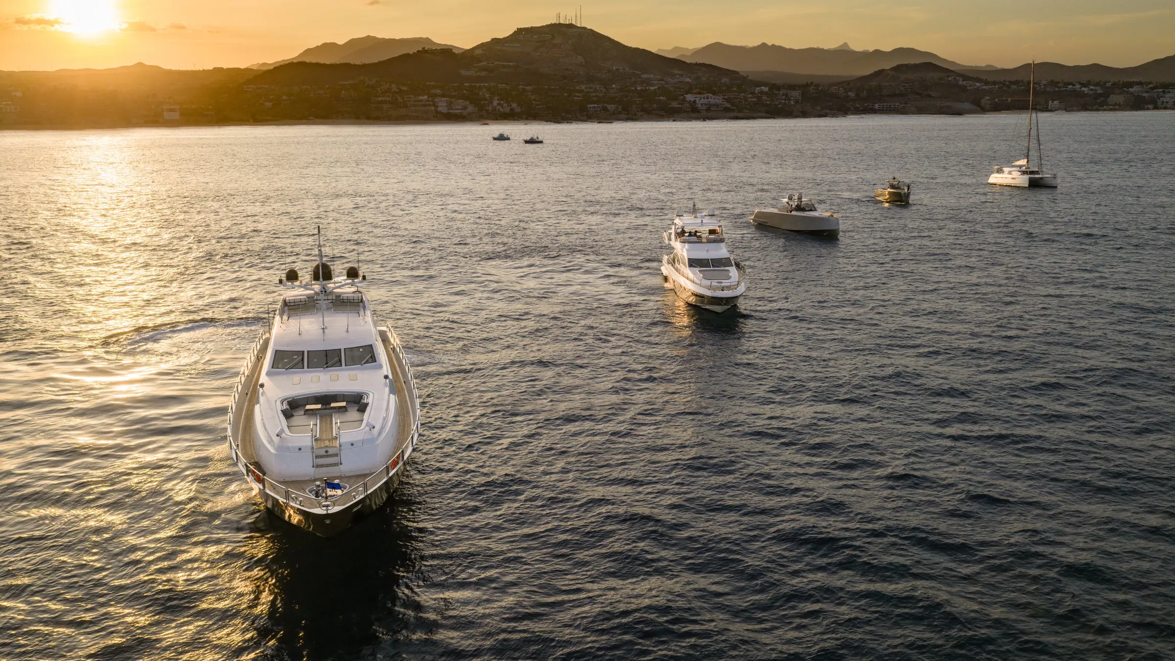 The Otaduy Yachts fleet under way off Los Cabos at sunset, aerial view