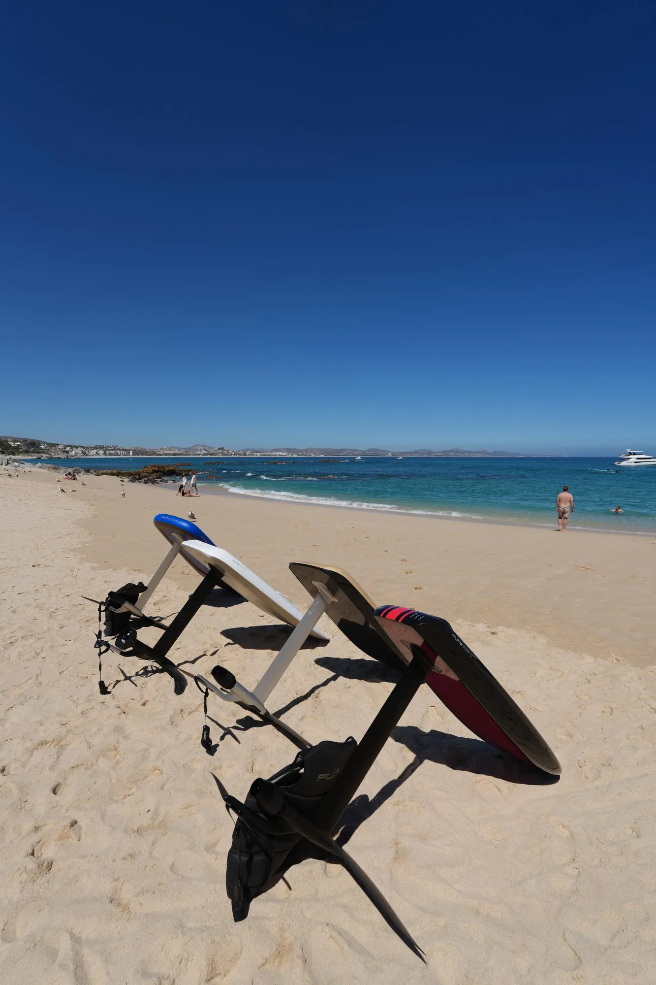 Fliteboard eFoils and gear lined up on the beach for a session
