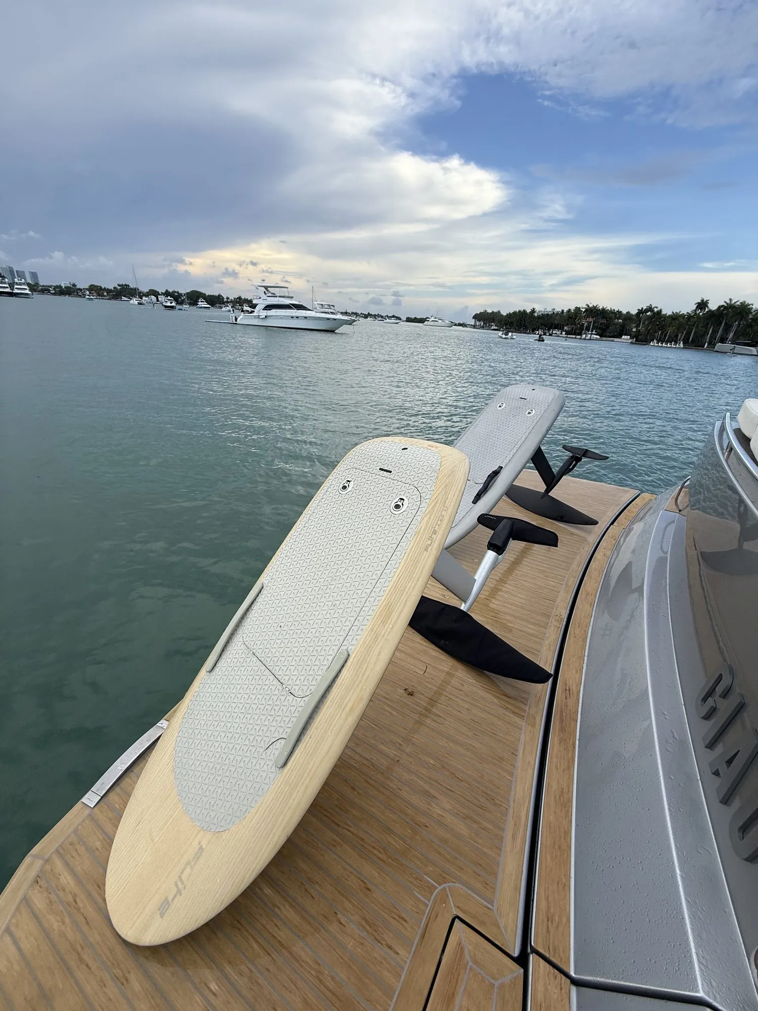 Two Fliteboard eFoils resting on the teak deck of a yacht