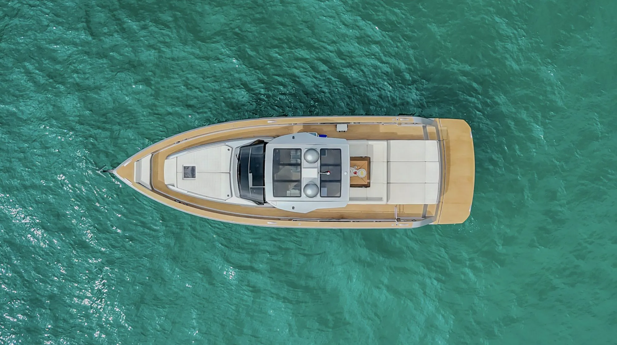 Top down aerial of CIAO at anchor in turquoise water