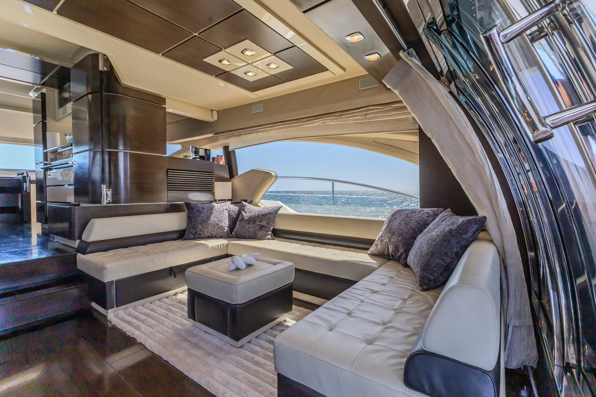 Main salon of Cardinale with cream leather seating and sea views