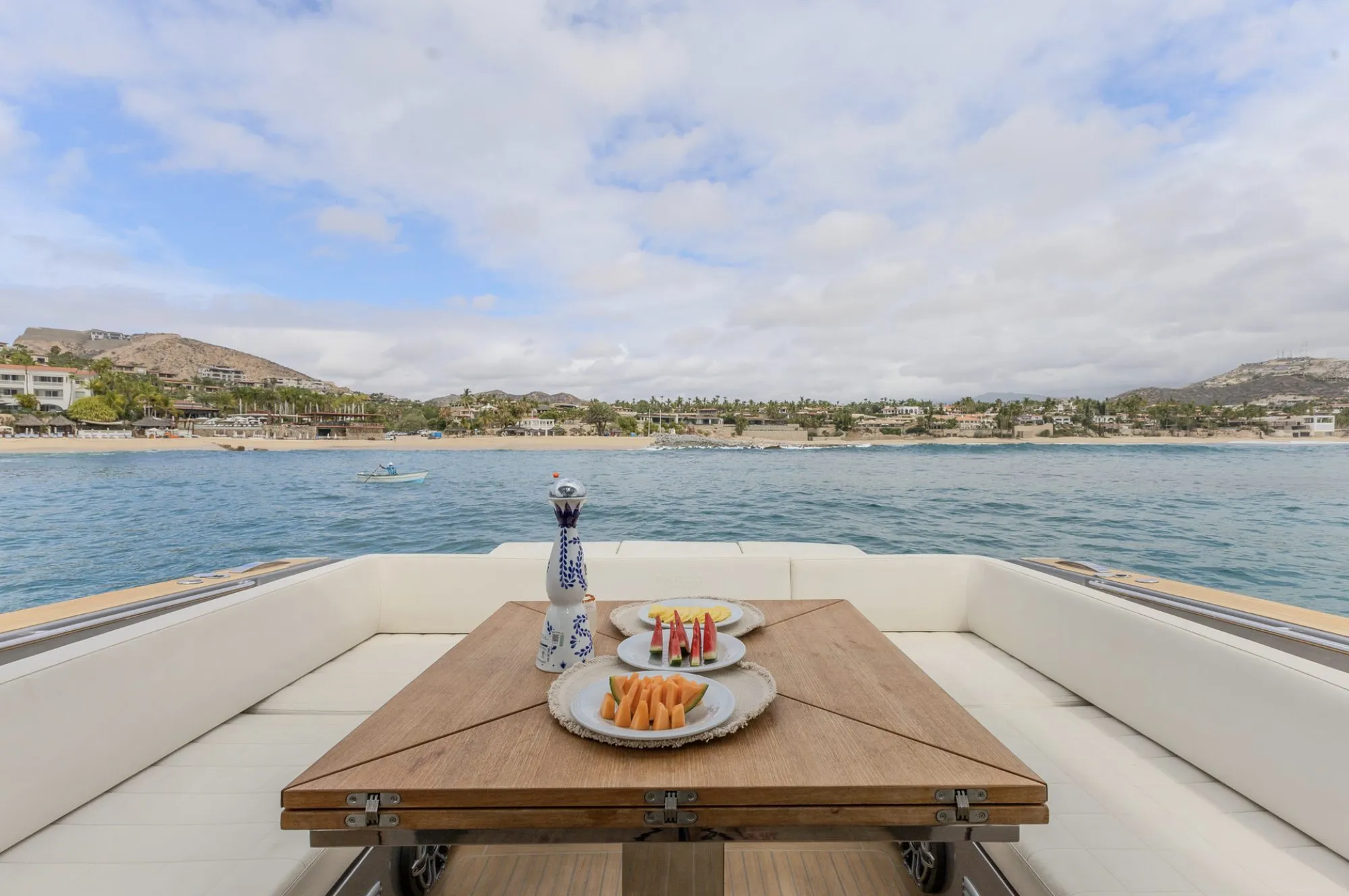 Cockpit table on CIAO set with fresh fruit facing the beach