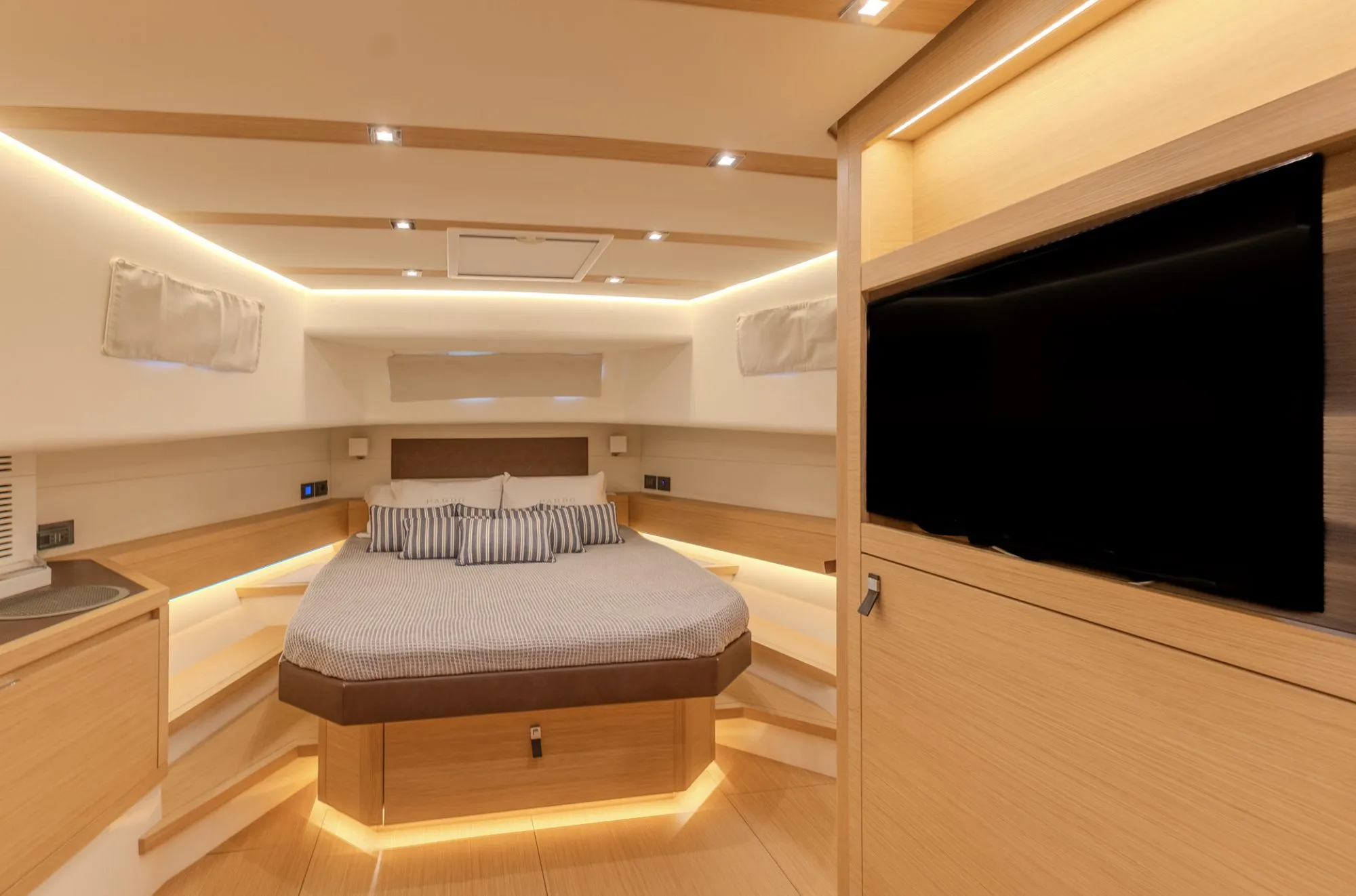 Owner cabin aboard CIAO with double bed and oak joinery