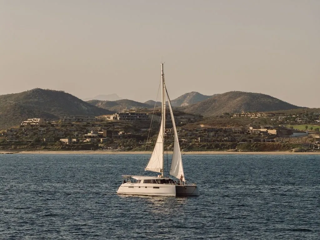 Telemachus sailing along the San José del Cabo shoreline at dusk