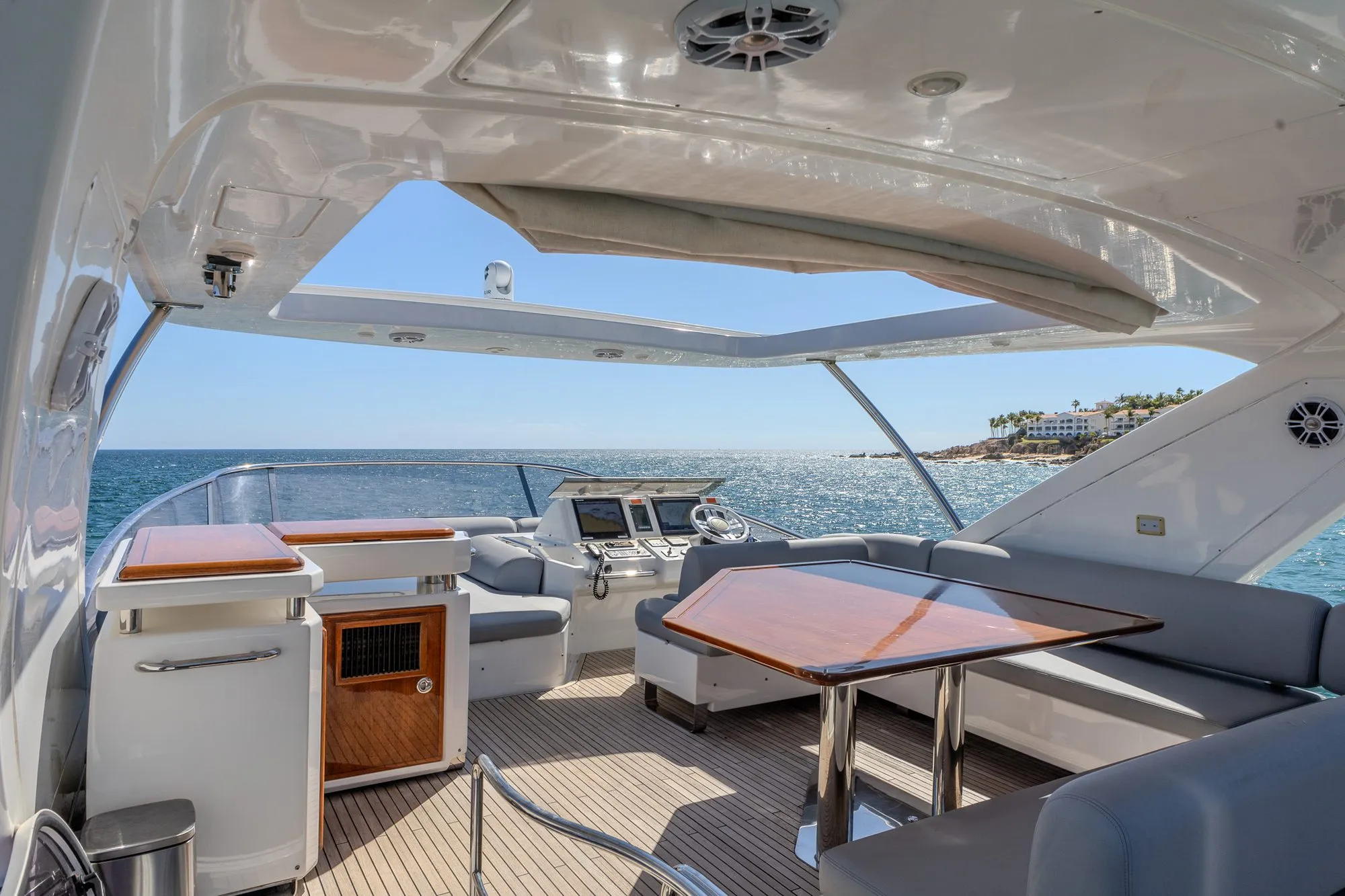 Flybridge of Cardinale with dining table, helm and shaded seating