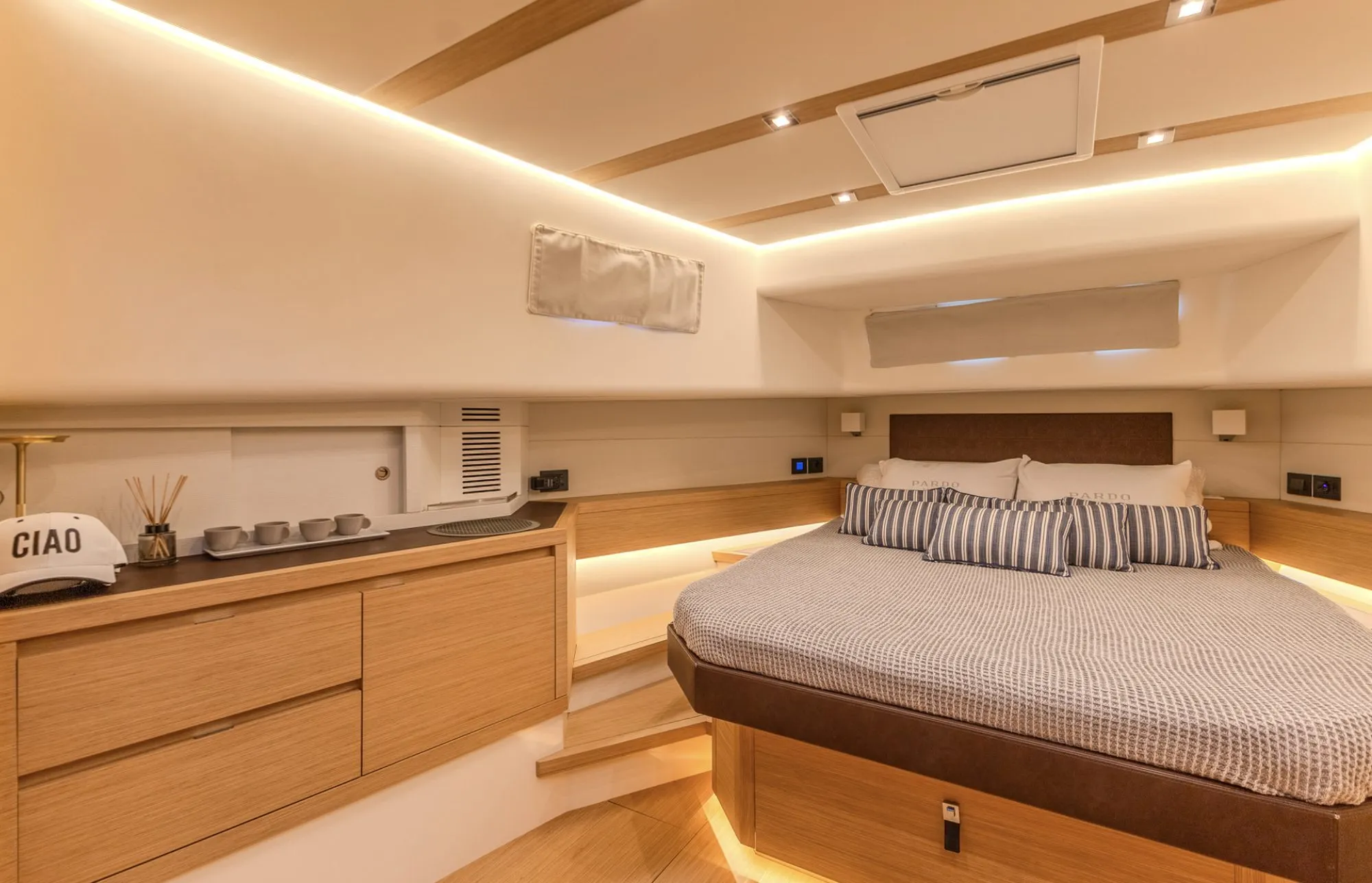 Guest cabin aboard CIAO with striped pillows