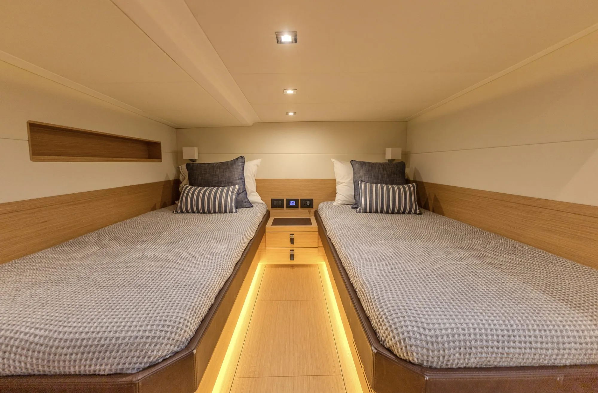 Twin guest cabin aboard CIAO with ambient floor lighting