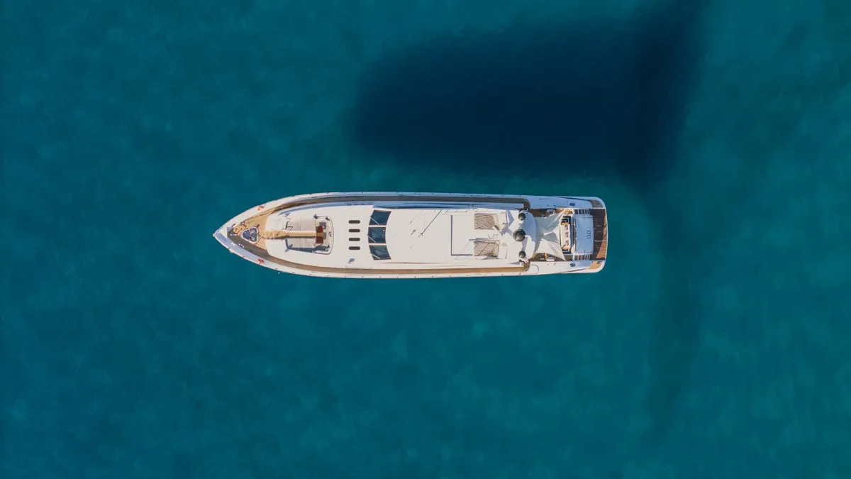 Top down aerial of GO at anchor over deep blue water