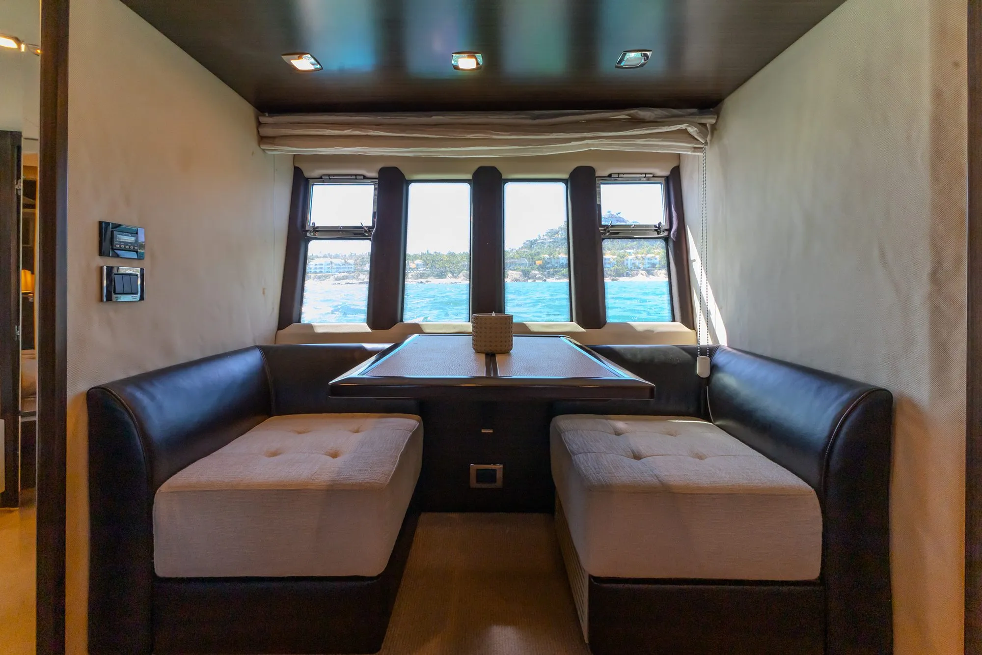 Lower deck dinette on Cardinale with leather banquettes and ocean view windows
