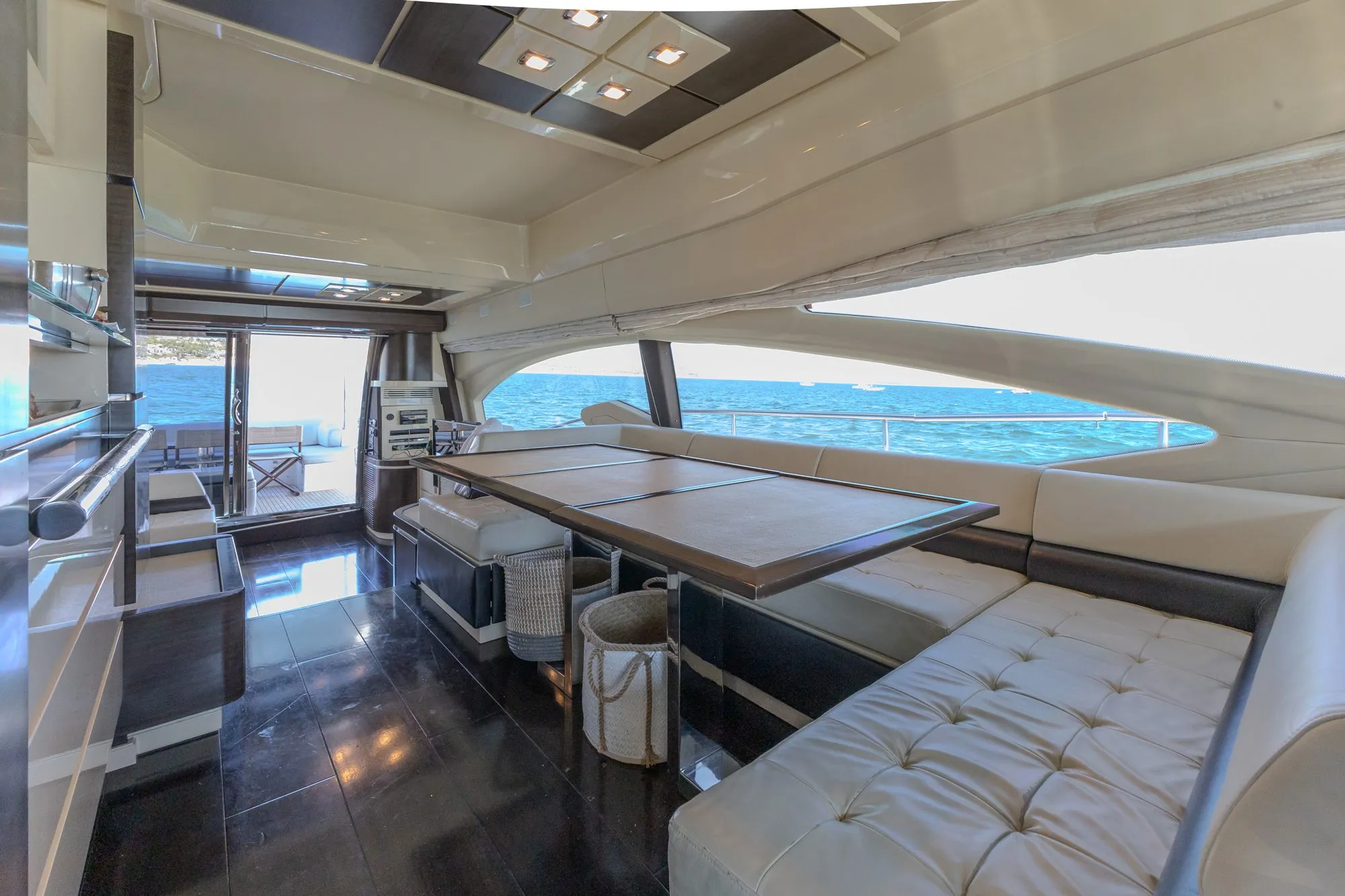 Cardinale salon dining table with wraparound leather seating and panoramic sea views