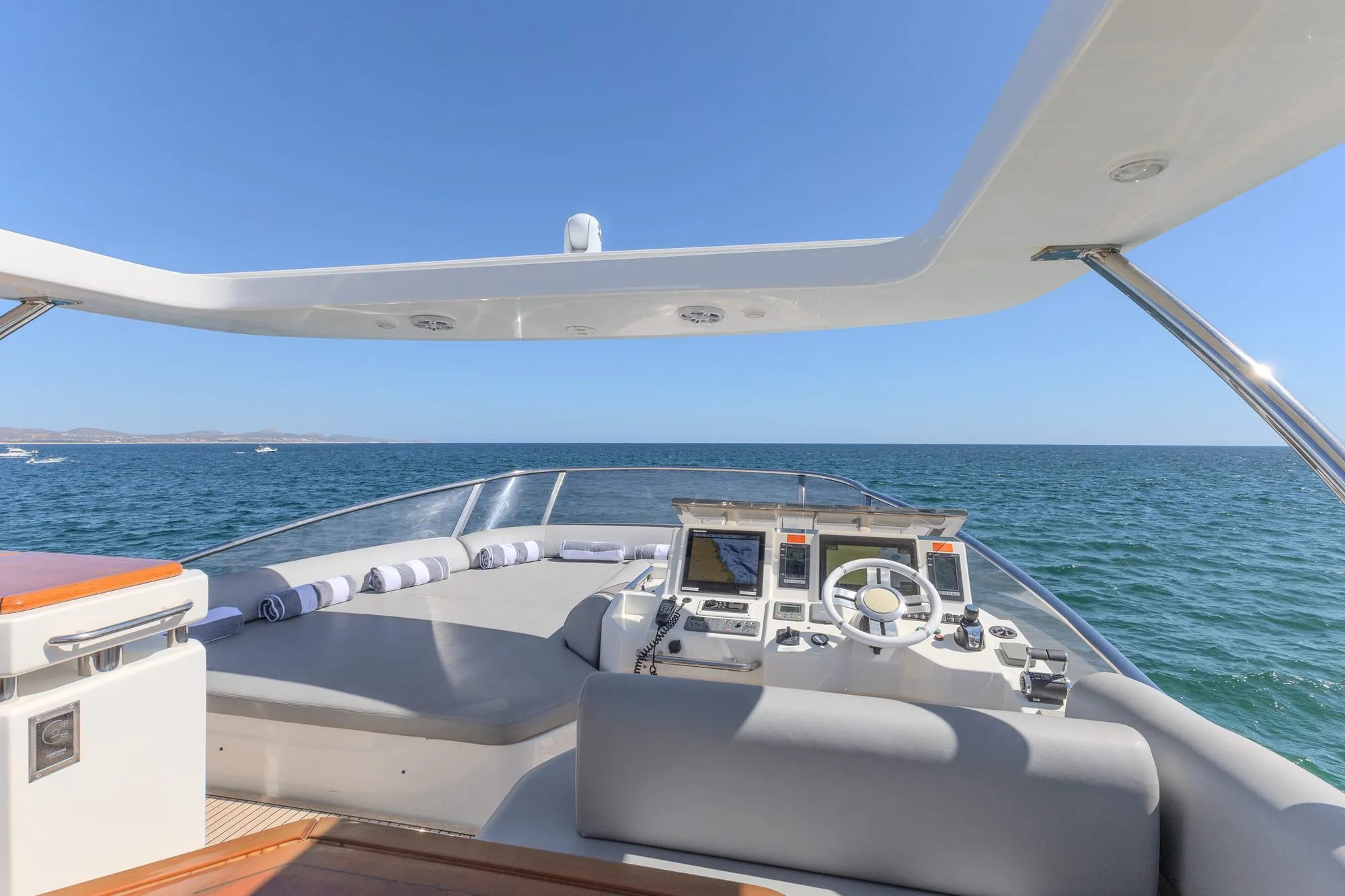 Cardinale flybridge helm station and forward sunpads under the hardtop