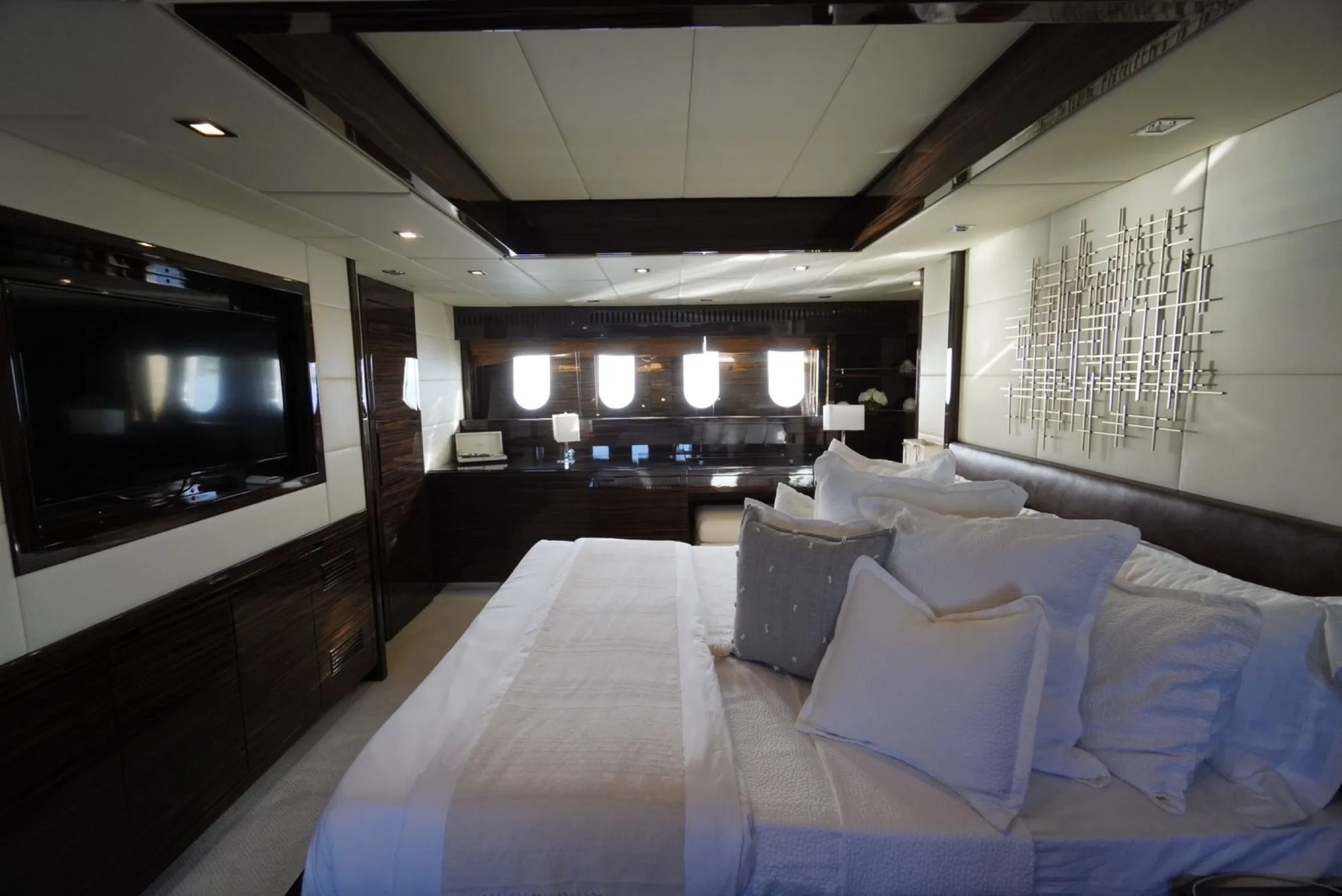Owner suite aboard GO with king bed and entertainment wall
