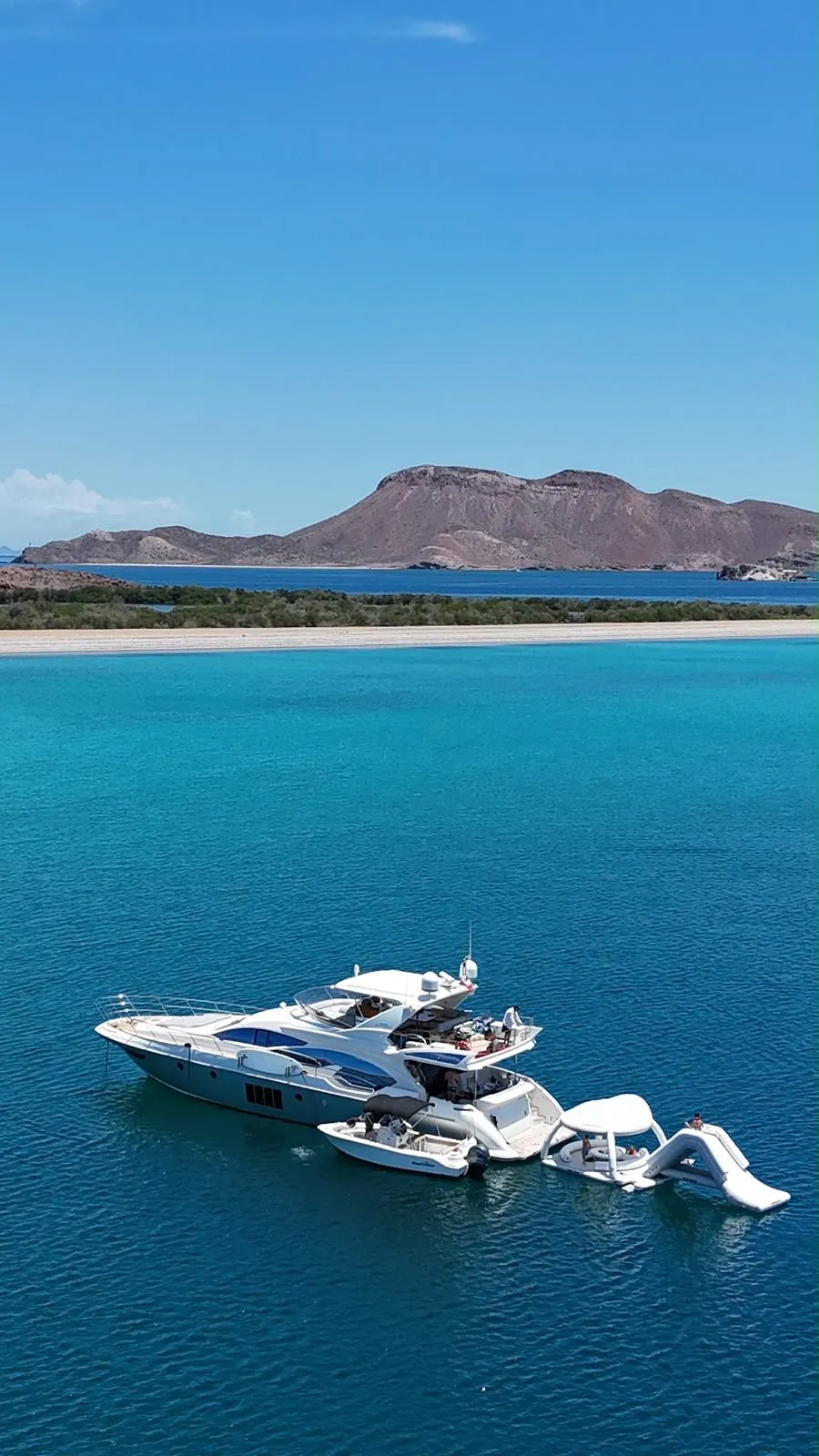 Aerial view of Cardinale anchored with tender and water toys deployed