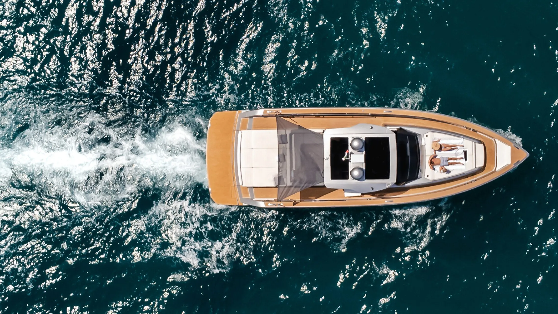 Top down aerial of CIAO underway leaving a white wake