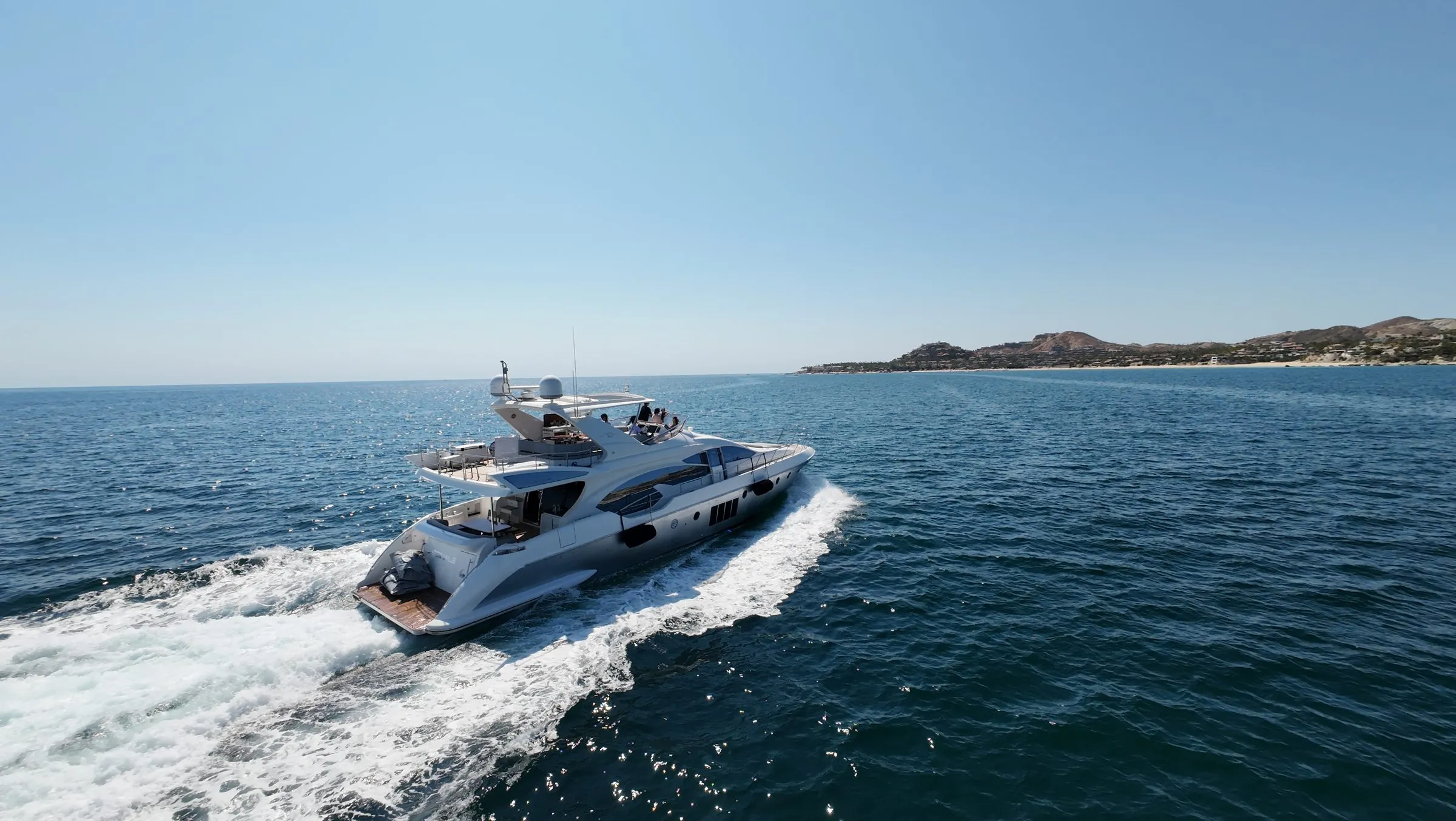 Cardinale running on open water off Los Cabos, aerial stern view