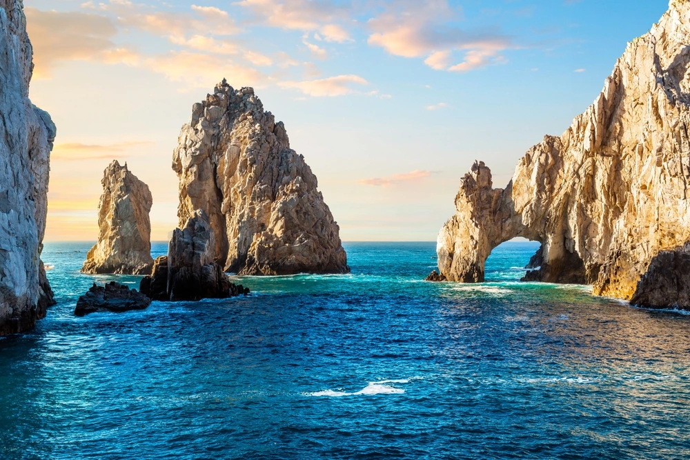 El Arco in Cabo San Lucas on bright blue water at dusk