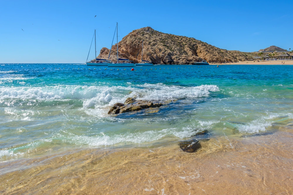 The waves rushing in on the beach at Santa Maria Bay