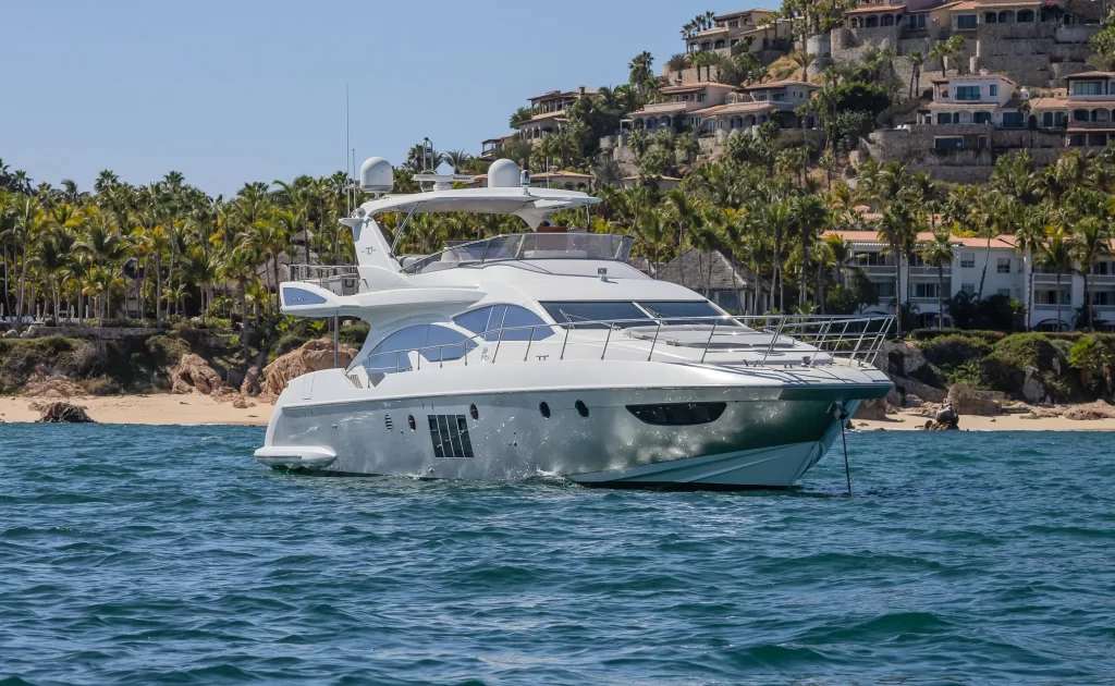 The Cardinale yacht floating by a beach.