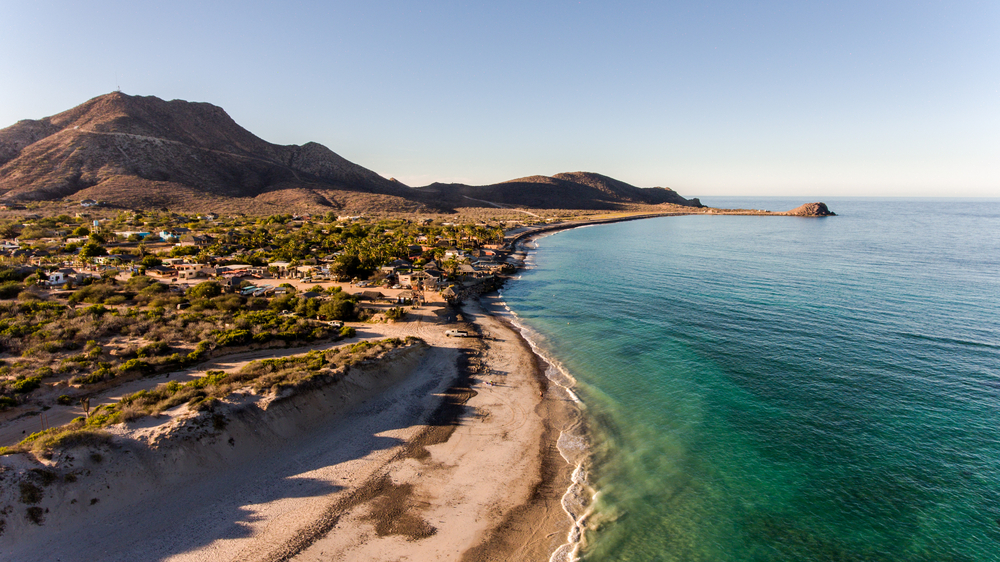Clear blue water brushing against the coast of Cabo Pulmo National Park.