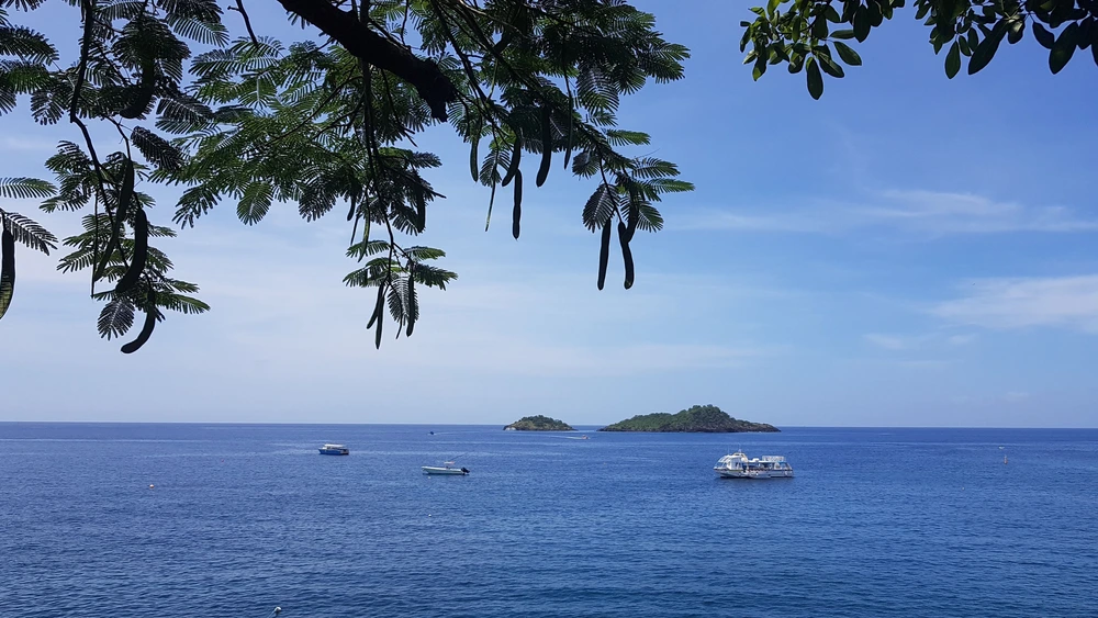 Isla Cerralvo in the distance with three vessels on a clear day.