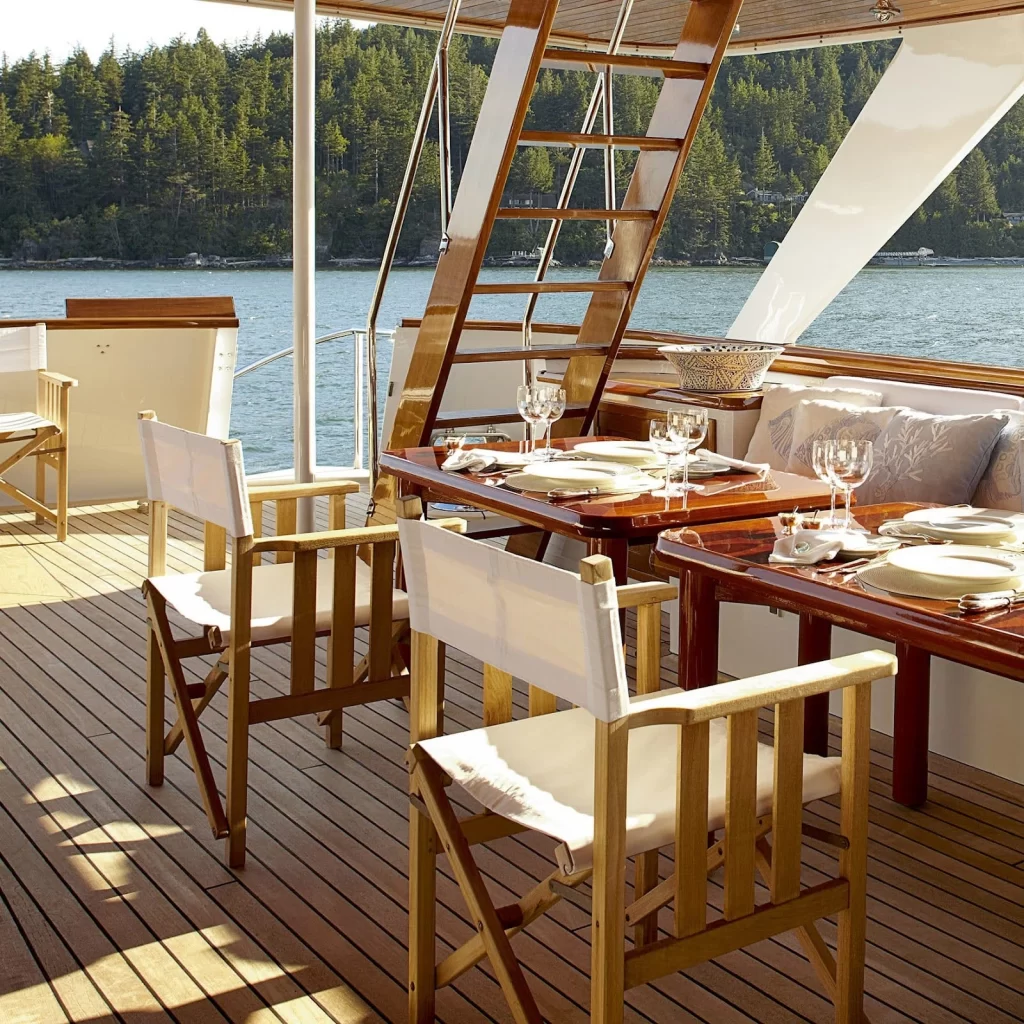 Yacht exterior with table and chairs. Tableware from Marine Business is displayed on the table.