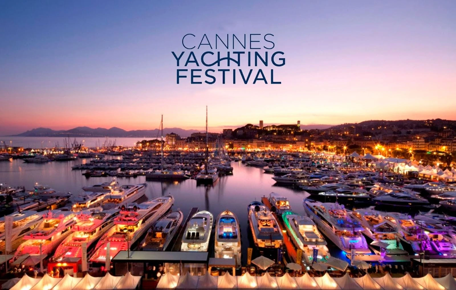 A view of the Cannes Yachting Festival with yachts in the Port of Cannes at sunset.