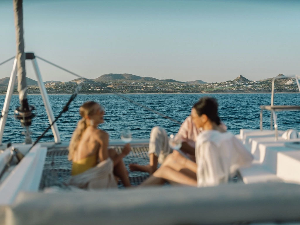 Two women talking and relaxing on the yacht deck of the Telemachus.